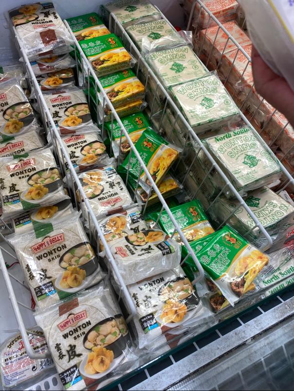 A photograph showing a freezer in a supermarket with packets of wonton pastry skins 