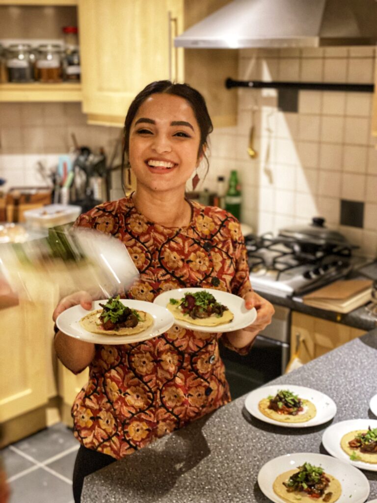 A photograph of Sohini preparing food in the kitchen